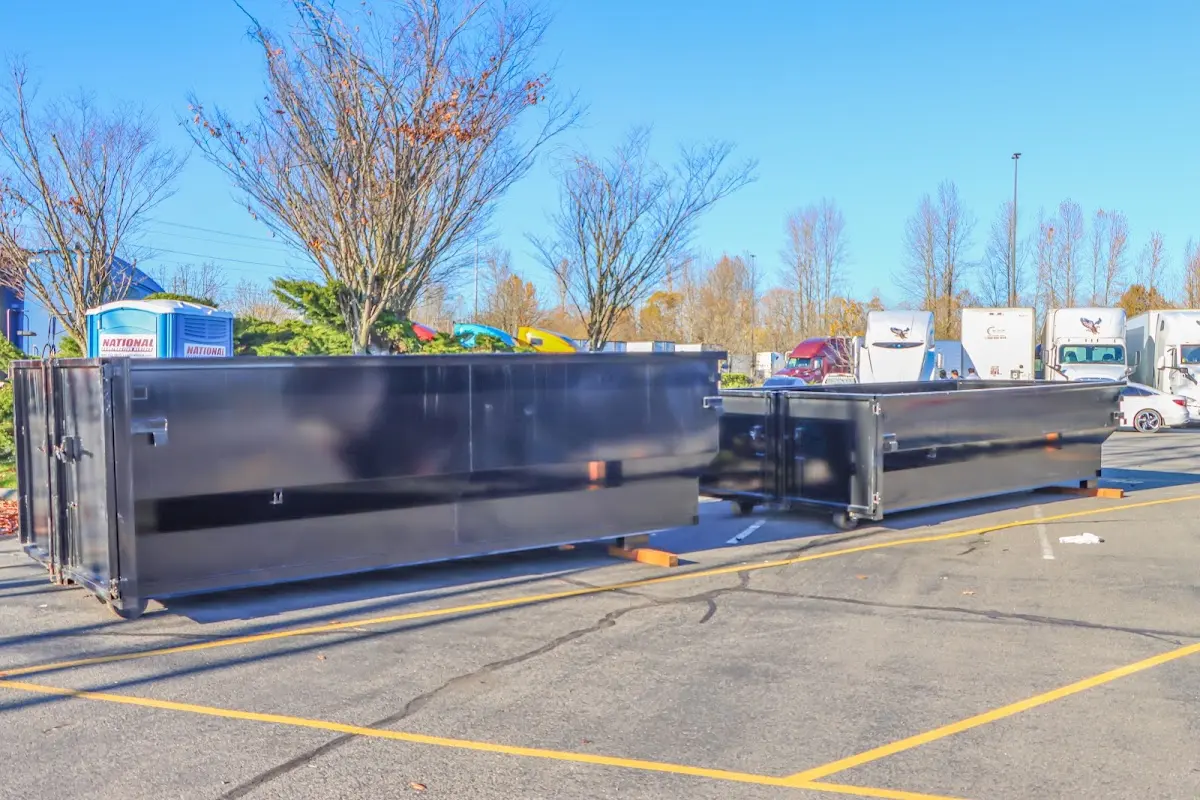 Professional dumpster rental service with roll-off container on residential driveway in Dothan